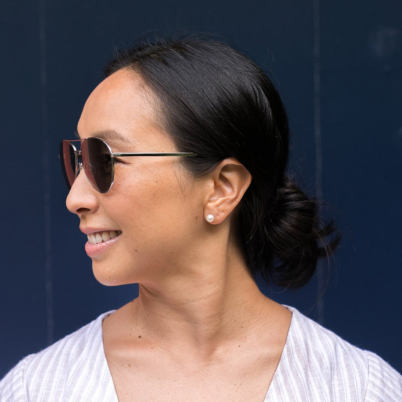 visible:Trina has a round face shape, extra low nose bridge, wide face width, med skin with warm undertones#color_Sparkling Silver with Polarized Gray Lenses